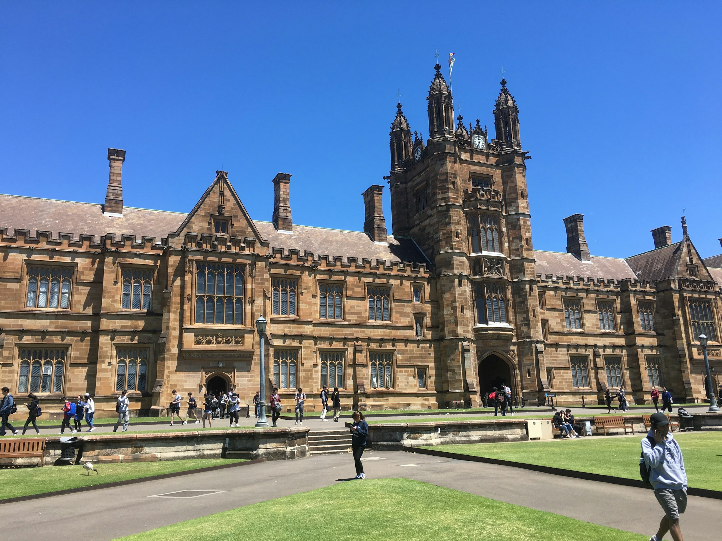 People walking near a historic university building